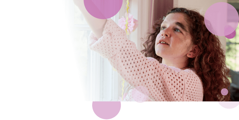 Kassidy, an 11-year-old living with NF1 PN, looking and reaching up