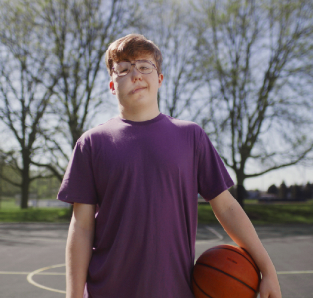 Quentin, a 16-year-old who takes Koselugo  for NF1 PN, standing holding a basketball